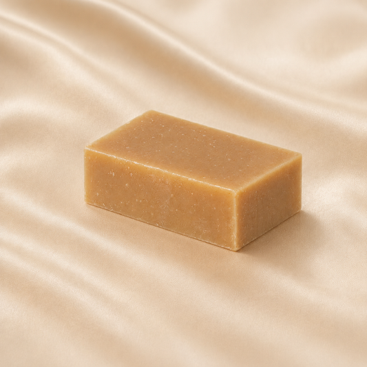 Mae Luna Patchouli Bliss tan botanical soap bar on softly lit cream satin.